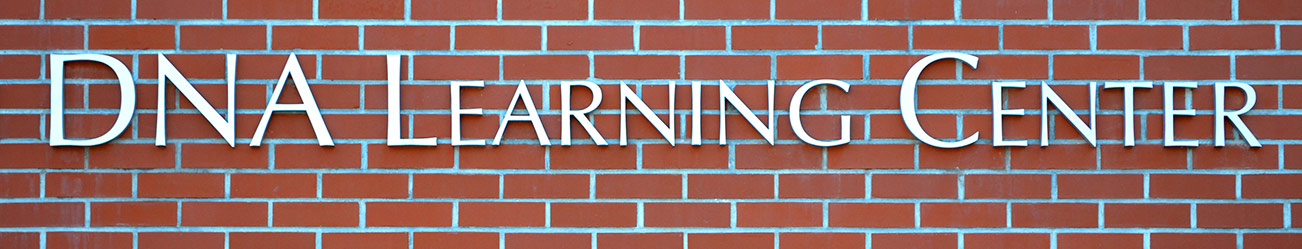 DNA Learning Center sign on red brick background